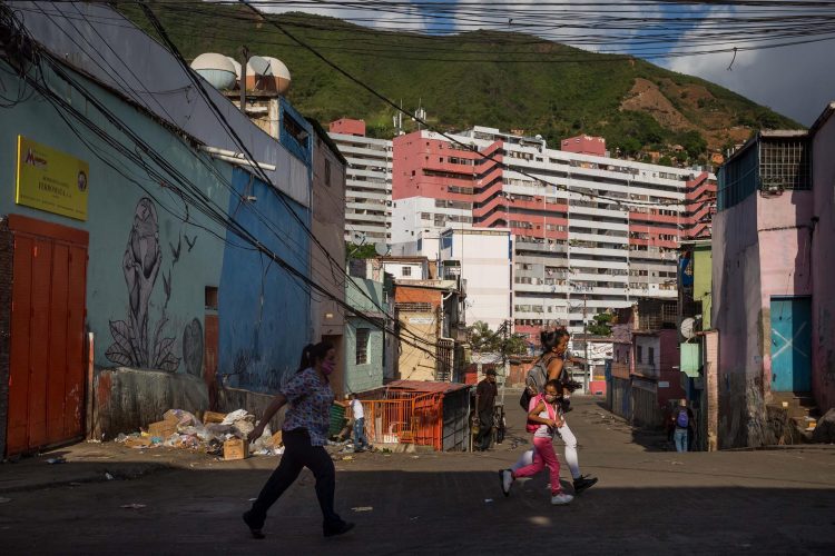 Fotografía tomada el pasado 15 de julio en la que se registró a varias personas al correr para cruzar una calle, mientras suenan disparos, en la barriada La Vega, en Caracas (Venezuela). EFE/Miguel Gutiérrez