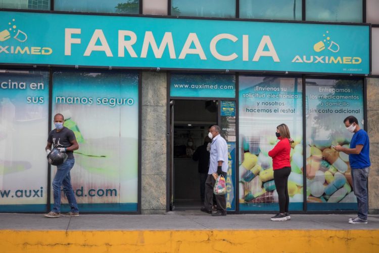 Fotografía de archivo de personas que hacen fila para abastecerse de medicamentos y productos de higiene personal en una farmacia de Caracas (Venezuela). EFE/ Rayner Peña