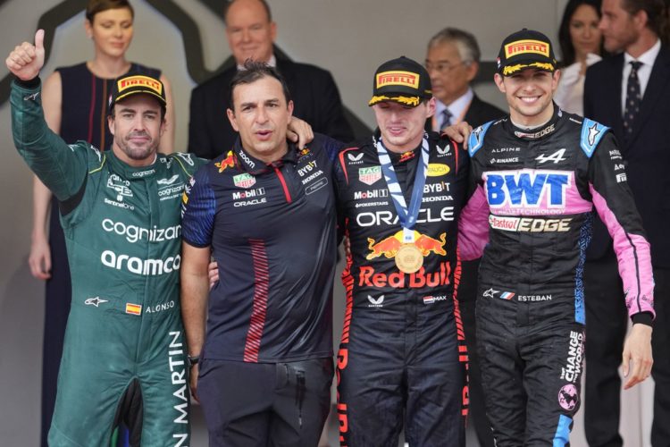 First place, Red Bull driver Max Verstappen of the Netherlands, second right, poses on the podium with second place, Aston Martin driver Fernando Alonso of Spain, left, and third place Alpine driver Esteban Ocon of France, right, during the Monaco Formula One Grand Prix, at the Monaco racetrack, in Monaco, Sunday, May 28, 2023. (AP Photo/Luca Bruno)