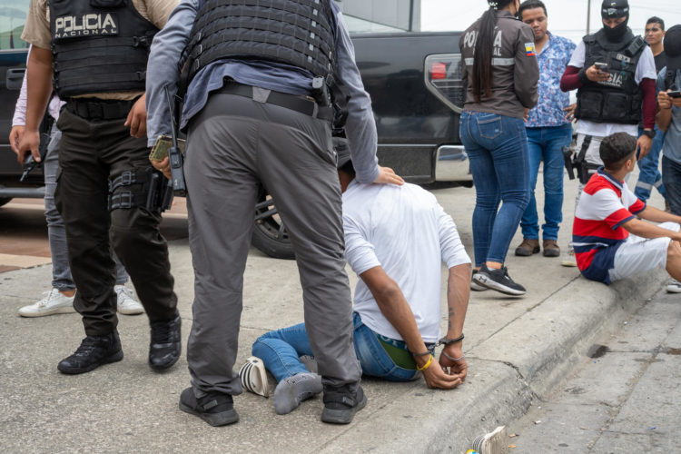Policías detienen hoy a un presunto delincuente a pocas cuadras de la sede del canal de televisión TC, donde encapuchados armados ingresaron y sometieron a su personal durante una transmisión en vivo, en Guayaquil (Ecuador). EFE/Mauricio Torres