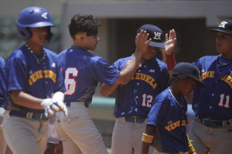 Ezequiel Zamora (2-i) de Venezuela celebra una carrera en la primera de la Serie del Caribe Kids, en una fotografía de archivo. EFE/ Bienvenido Velasco