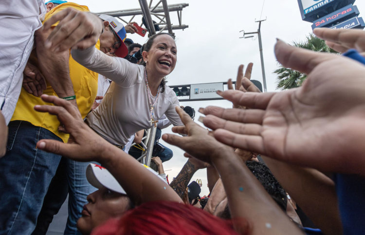 La líder opositora María Corina Machado saluda a sus simpatizantes en un acto político en una avenida en Maracaibo (Venezuela). EFE/ Henry Chirinos