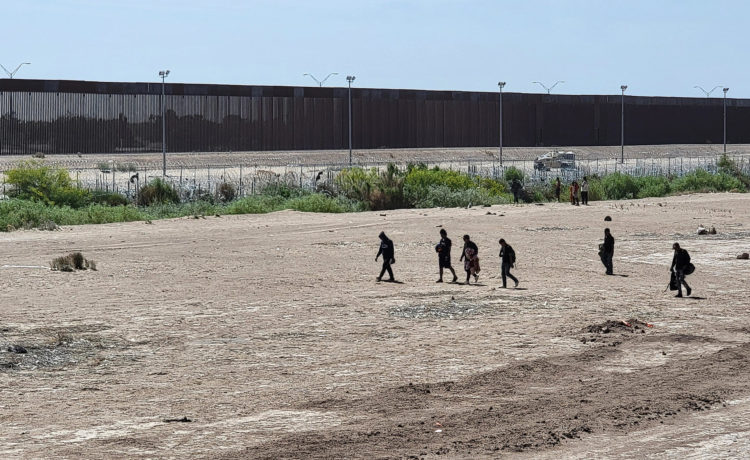 Foto de archivo de migrantes caminando por una orilla de la línea divisoria entre México y EE.UU., en Ciudad Juárez, en el estado de Chihuahua (México). EFE/ Luis Torres