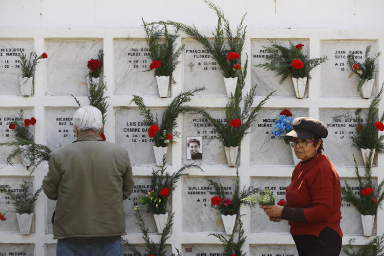 Fotografía de archivo en donde se personas dejan flores en el Memorial de Detenidos Desaparecidos y Ejecutados Políticos, en el Cementerio General de Santiago (Chile). EFE/ Elvis González