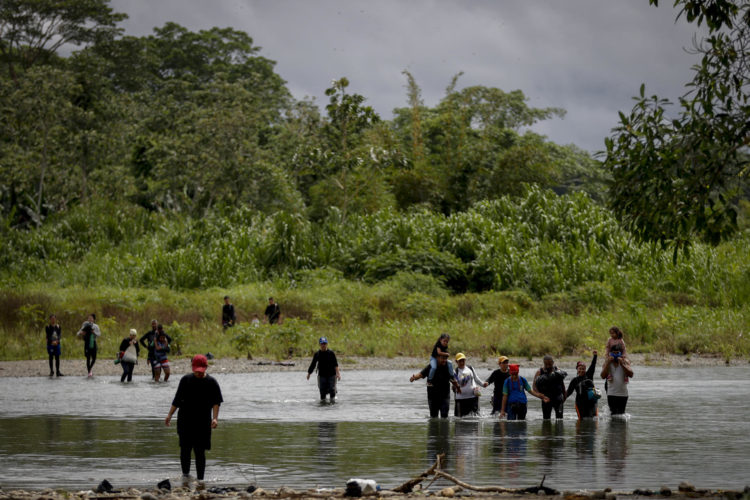 Migrantes cruzan el río Tuquesa luego de atravesar la selva del Darién, este jueves en el Darien (Panamá). El director de la Aecid, Antón Leis, visitó esta semana el poblado al que llegan a diario cientos de migrantes tras atravesar durante días la peligrosa selva del Darién, la frontera natural entre Colombia y Panamá, donde recordó que nadie "recorre miles de kilómetros por capricho y mucho menos para cometer delitos", sino porque huyen de guerras, hambre o miseria, las causas profundas de la crisis migratoria global. EFE/ Bienvenido Velasco