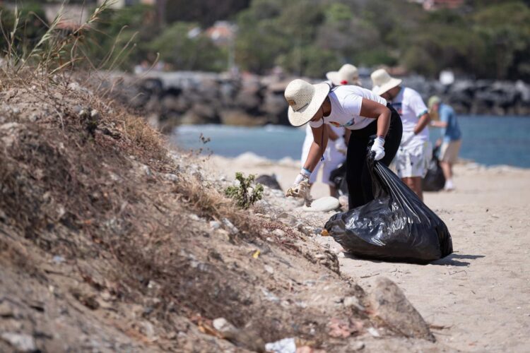 Una mujer recoge basura durante una jornada de limpieza de playas con el apoyo de la Delegación de la Unión Europea, este sábado en la playa Macuto de La Guaira (Venezuela). EFE/ Ronald Peña R