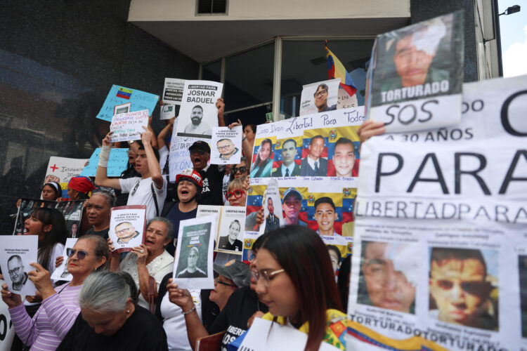 Fotografía de archivo de personas mientras sostienen carteles con imágenes de presos políticos en Caracas (Venezuela). EFE/ Miguel Gutiérrez