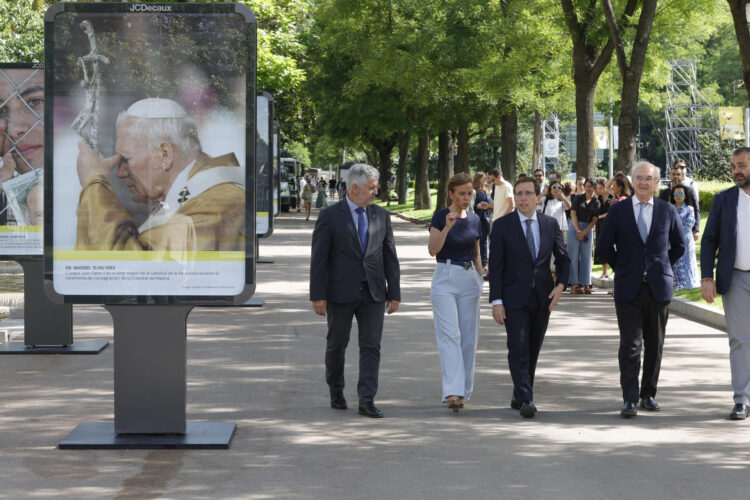 El alcalde de Madrid, José Luis Martínez-Almeida (c) y el presidente de la Agencia EFE, Miguel Ángel Oliver (i) durante la presentación de la exposición fotográfica al aire libre, con motivo de la visita del papa León XIV a la capital, dedicada a repasar las visitas históricas que realizaron los papas Juan Pablo II y Benedicto XVI, en Madrid este lunes. EFE/ Zipi
