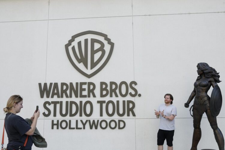 Fotografía de archivo del 21 de octubre de 2025 que muestra a personas posando frente al lugar donde se realiza el recorrido por los estudios Warner Bros. de Burbank, California (EE.UU.). EFE/EPA/CAROLINE BREHMAN /ARCHIVO
